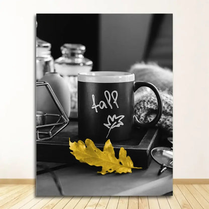 Black ceramic mug with white fall lettering and leaf design beside yellow leaf in DecorBites™ nordic landscape canvas set