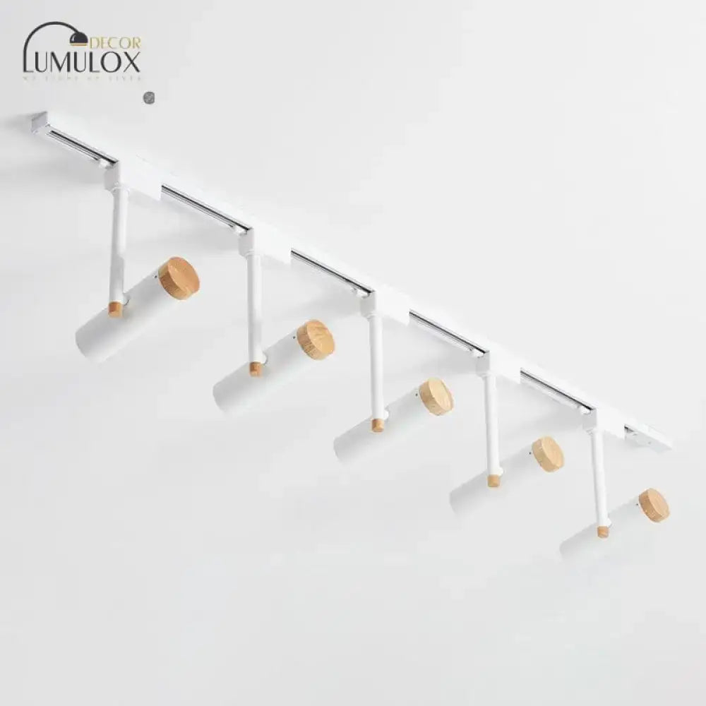 White track lighting system featuring wooden caps on each fixture from DecorBites™ nordic tubular metallic spotlight