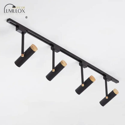Black cylindrical track lighting fixtures with natural wood caps by lumulox from decorbites™ nordic tubular spotlight series