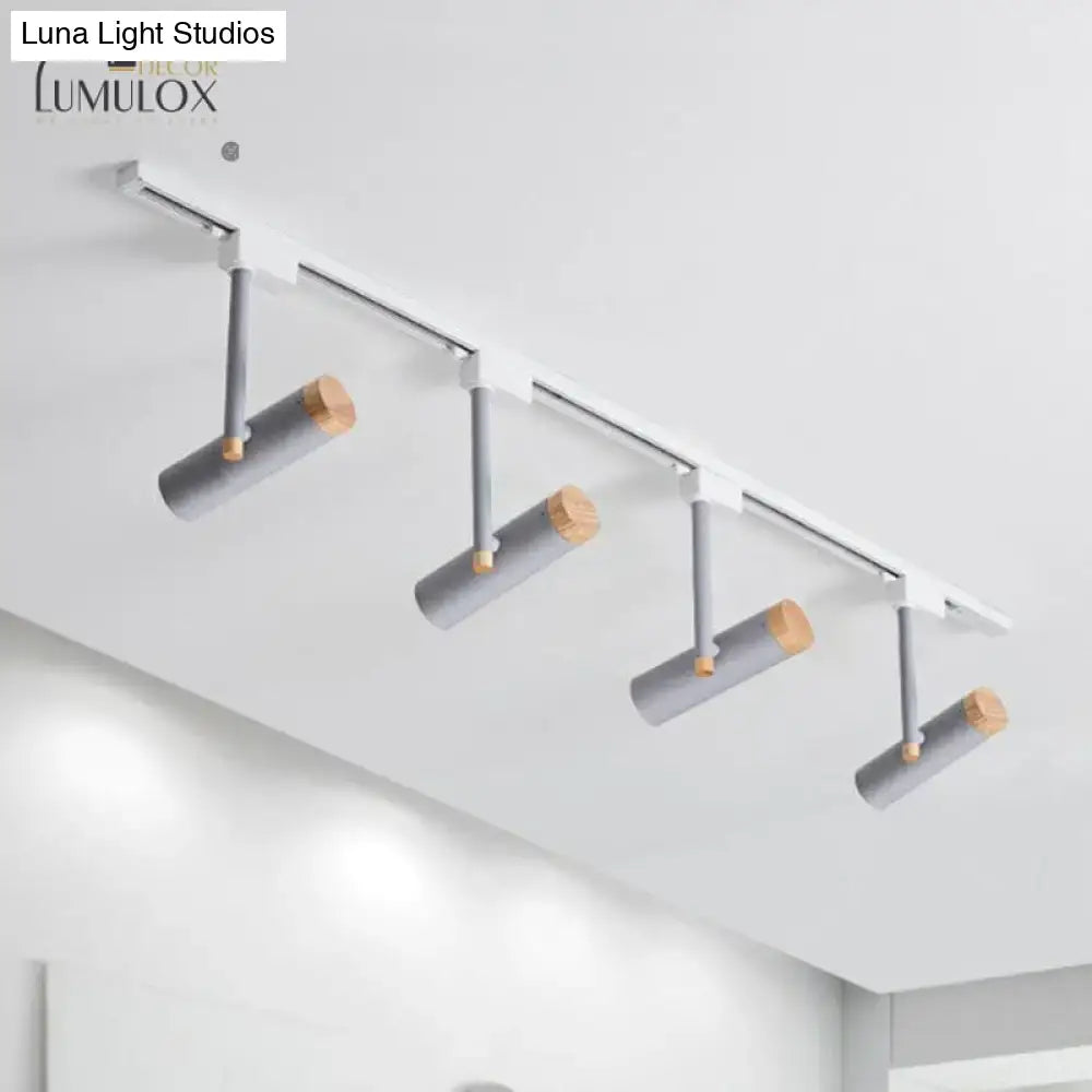 Modern track lighting system with four gray cylindrical fixtures featuring wood caps and metallic arms by DecorBites™