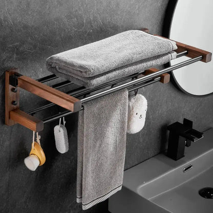 Modern black and wood bathroom hardware set by decorbites featuring a towel rack with gray towels and storage shelf