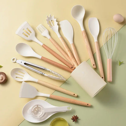 Set of white silicone kitchen utensils with light wood handles in black and wood silicone kitchen utensil set box