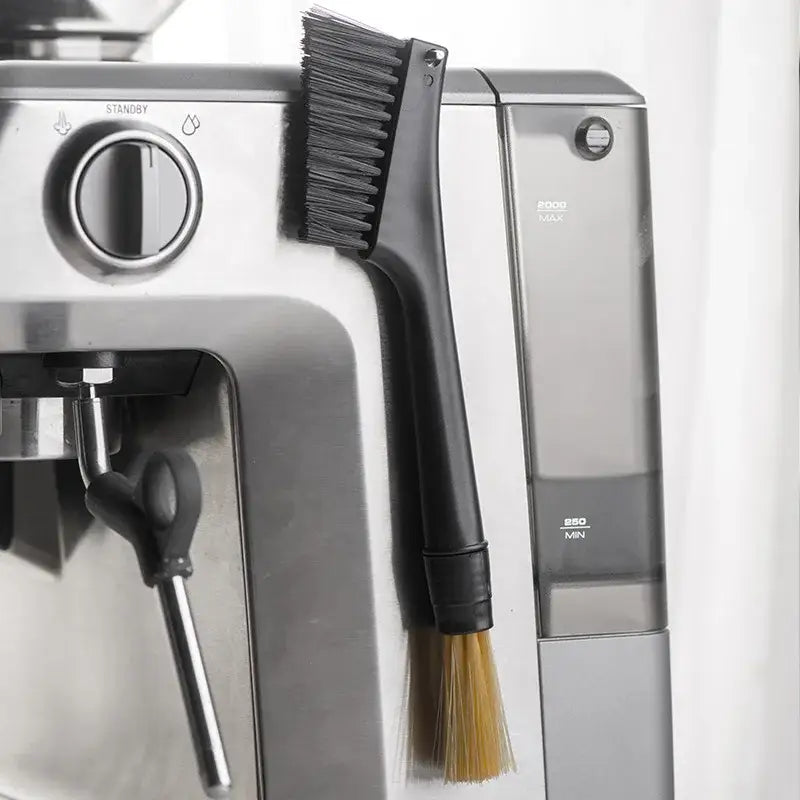 Black and yellow dual head coffee grinder brush with dense dark and lighter tan bristles for cleaning espresso machines