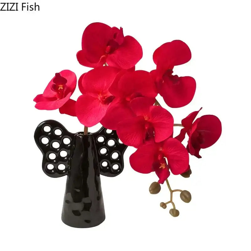 Black angel elephant ceramic vase with circular cutouts holding vibrant artificial flowers for living room decorbites decor
