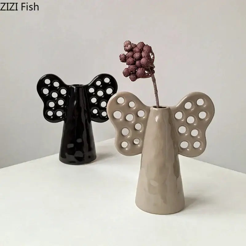Beige ceramic angel-shaped vase with perforated wings and matte finish for artificial flowers decorbites elephant ceramic vase