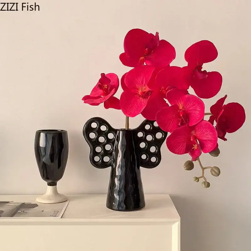 Black angel elephant ceramic vase with circular cutouts and glossy finish holding vibrant artificial flowers decorbites elephant ceramic vase for living room decor