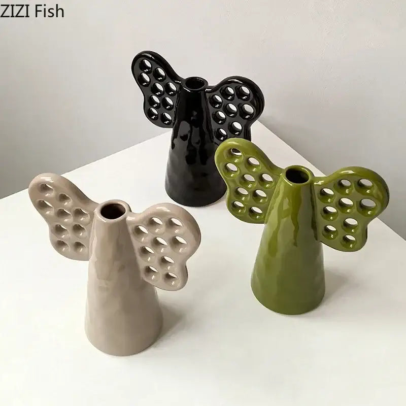 Black olive green and beige ceramic angel vases with perforated wings featuring artificial flowers decorbites elephant ceramic vase