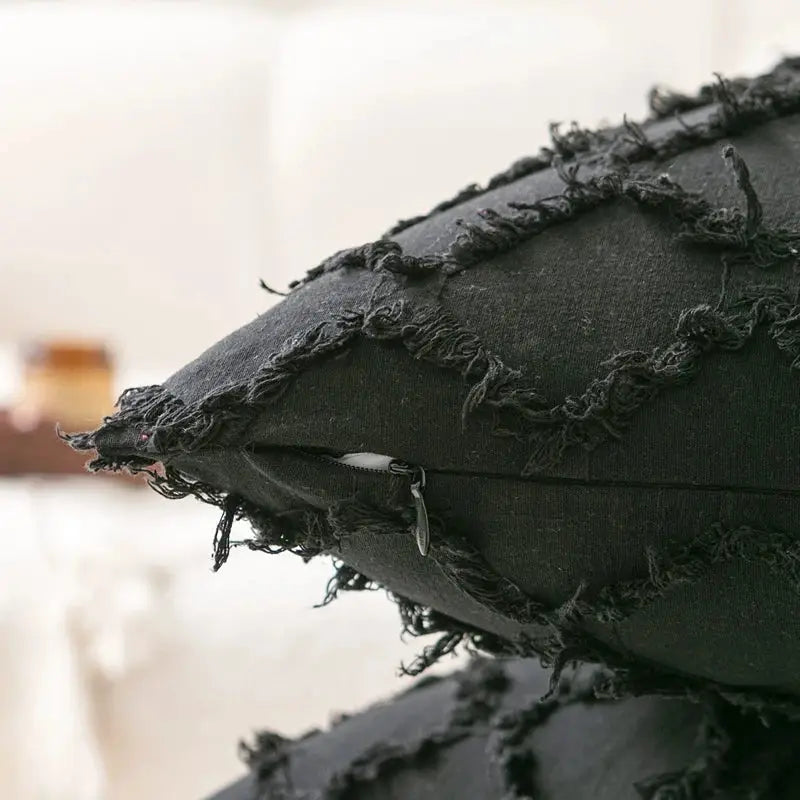 Dark gray distressed fabric pillow cover with frayed edges and visible zipper decorbites black boho lumbar decor