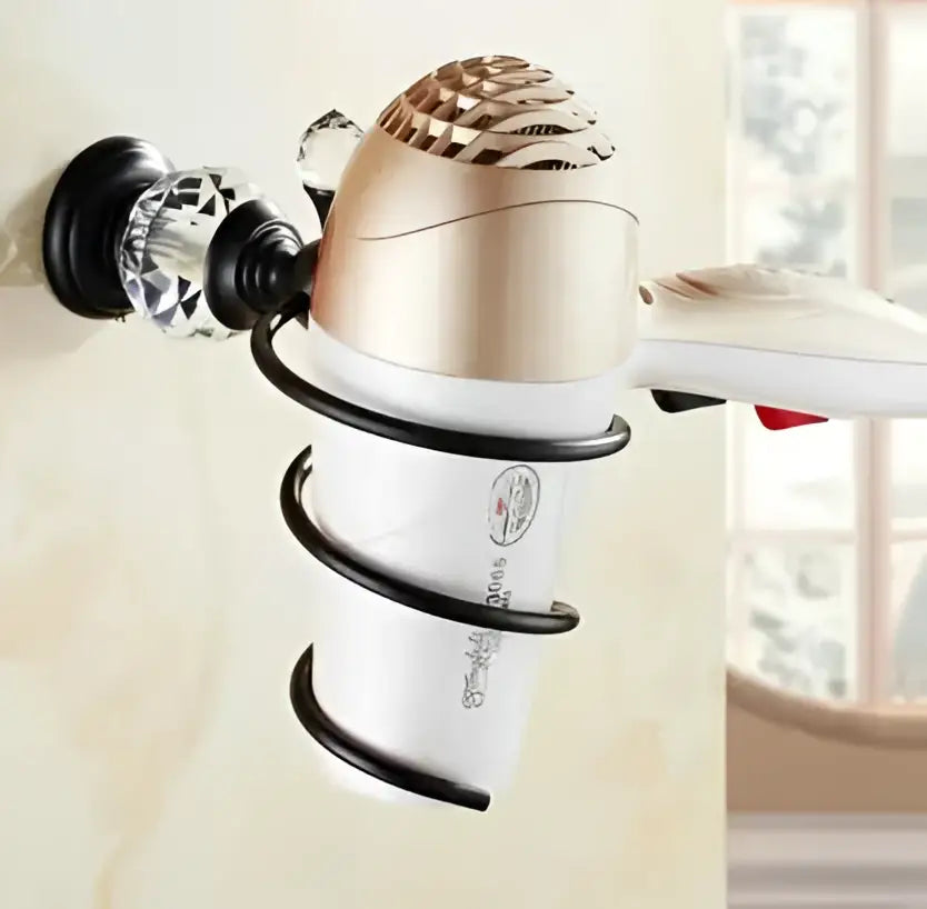 Gold and white hair dryer mounted in black spiral wall holder from black brass bathroom accessories set