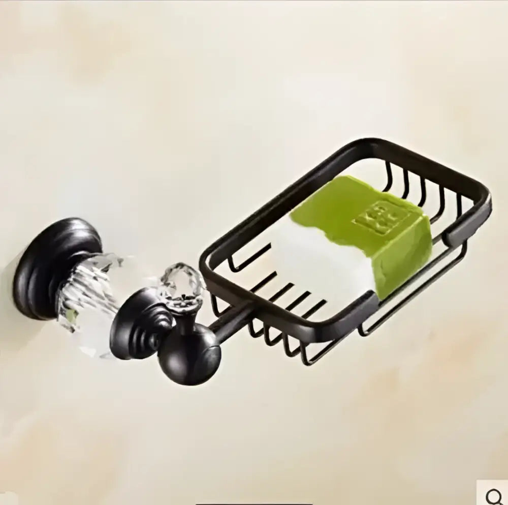 Black metal soap dish with crystal knobs holding a green soap bar from black brass bathroom accessories set