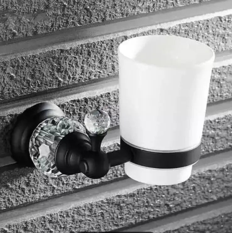 Black and white ceramic toothbrush holder with crystal accents in black brass bathroom accessories set
