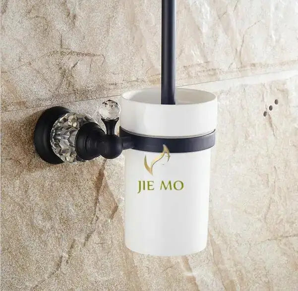 White ceramic toilet brush holder with black brass mounting bracket and crystal knob in bathroom accessories set