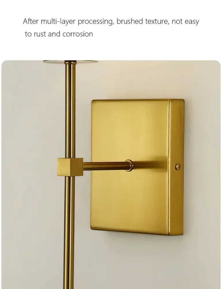 Gold-toned brushed metal wall sconce with rectangular backplate and slender arm for black brass fabric shade bedroom light