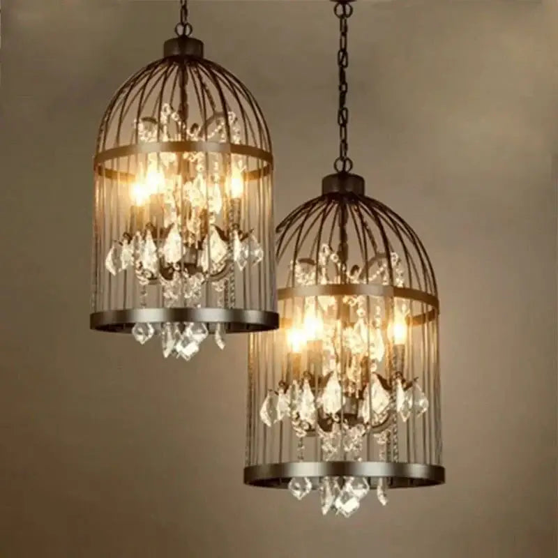 Two ornate black and bronze iron birdcage crystal chandelier pendant lights with dark metal frames and crystal droplets