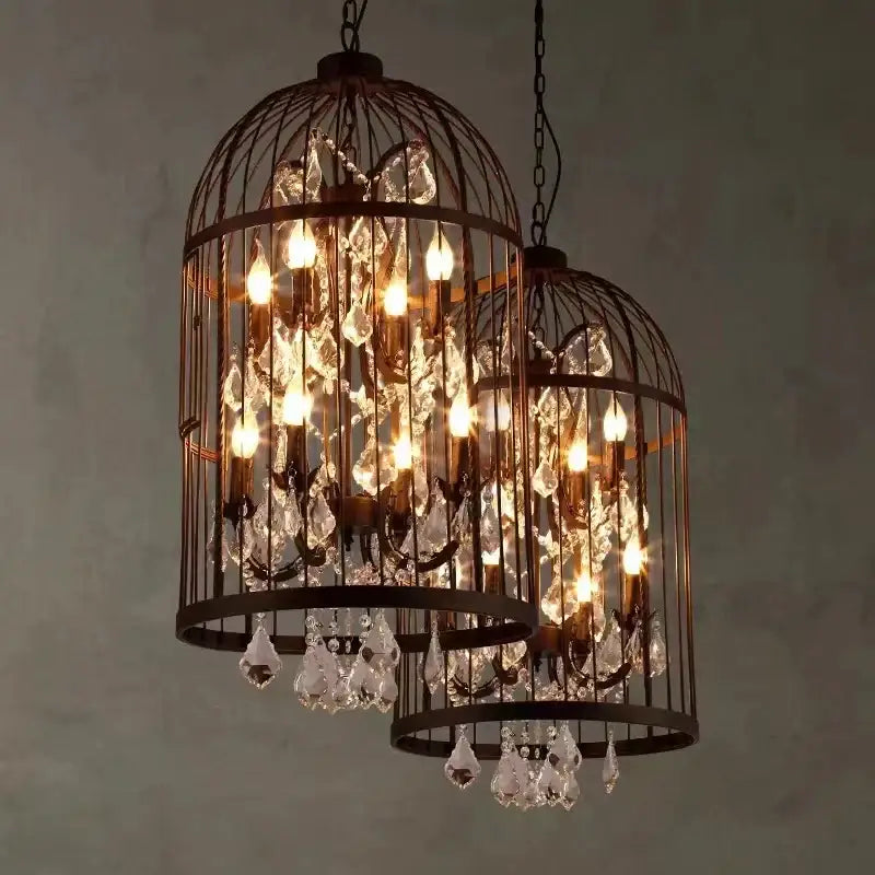 Two illuminated black and bronze iron birdcage crystal chandeliers with dangling crystals for dining room decorbites iron birdcage
