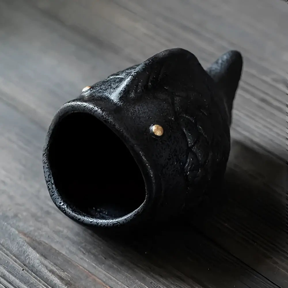 Black ceramic ashtray shaped like a cartoon cat fish with textured scales and small gold dot for decorbites cartoon cat decor