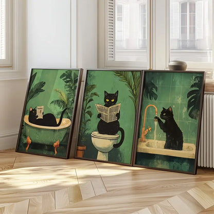 Set of three framed black cat wall art illustrations featuring bathroom-themed scenes on green background for decorbites