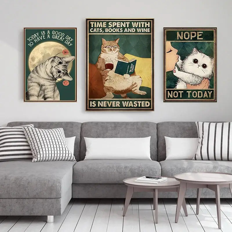 Three framed cat-themed posters including decorbites™ black cat reading music poster above gray sectional sofa