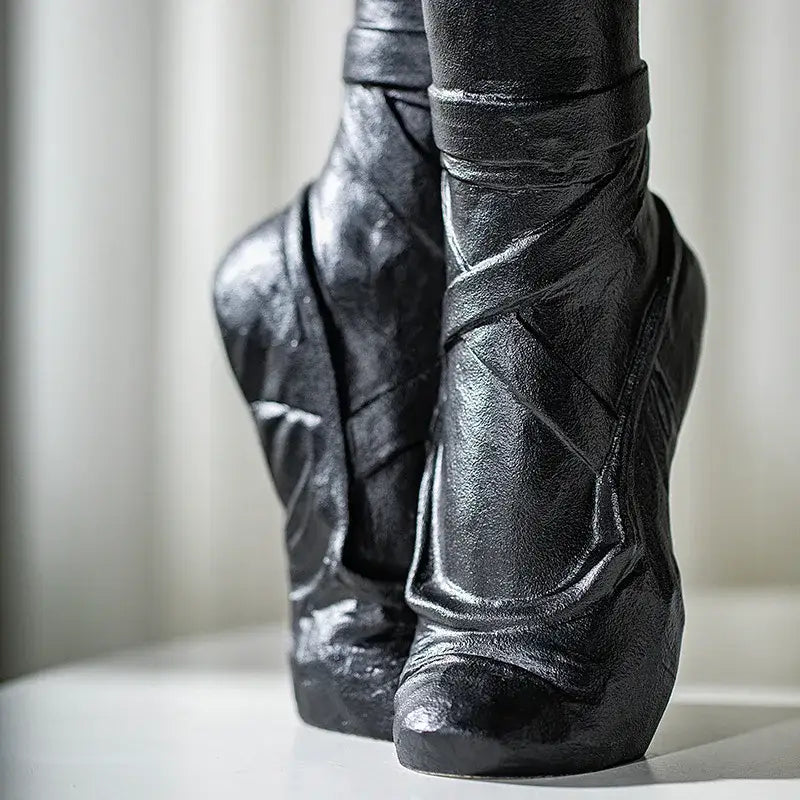 Black ceramic ballet shoes vase featuring sculpted ballet shoes with detailed ribbed texture and glossy finish for bedroom decor