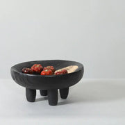 Black ceramic decorbites imitation wood grain corner tray bowl with textured surface and three short legs holding red tomatoes