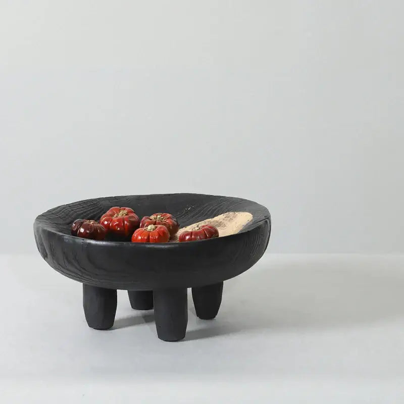 Black ceramic decorbites imitation wood grain corner tray bowl with textured surface and three short legs holding red tomatoes