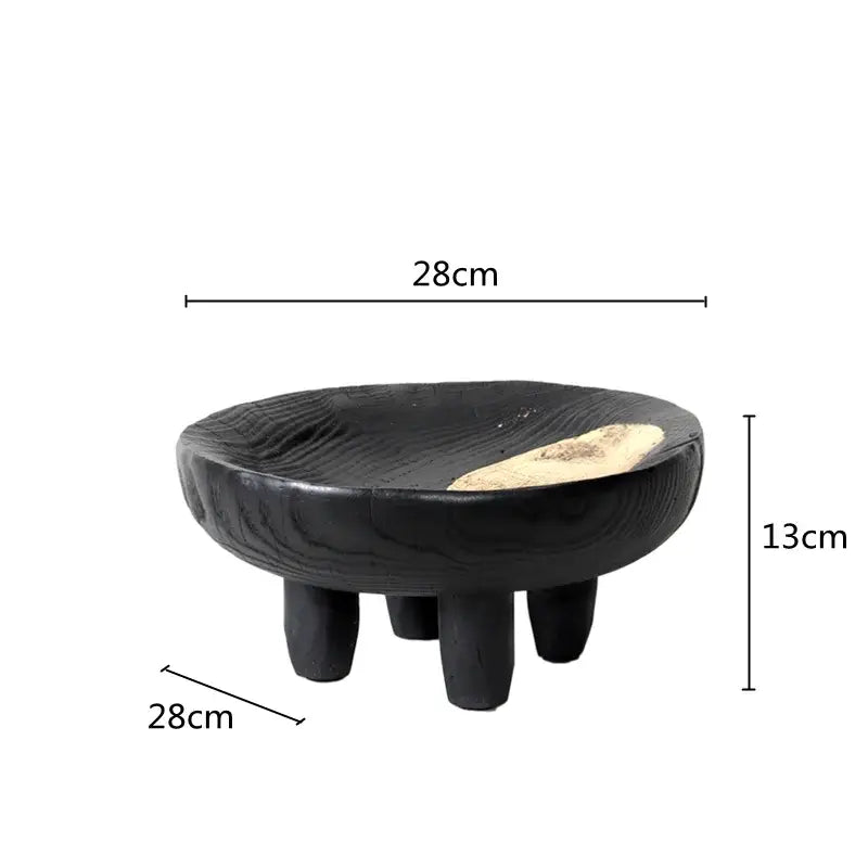 Black wooden footstool with wood grain finish and light patch paired with black ceramic decorbites imitation wood grain corner tray