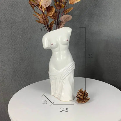White ceramic human body figurine vase shaped like female torso with draped fabric and studded breasts decorbites