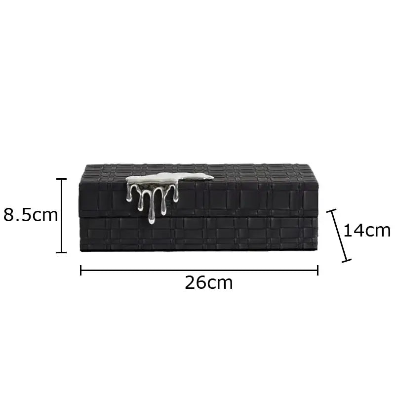 Black crocodile leather jewelry box with a textured brick-like surface and silver drip clasp for elegant storage