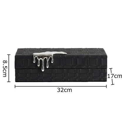Black crocodile leather jewelry box with woven texture and silver drip clasp for elegant jewelry storage