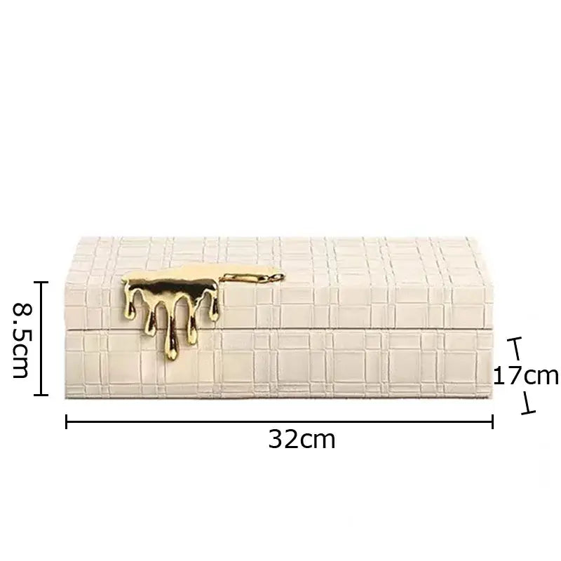Cream-colored leather jewelry box with crocodile skin texture and gold-tone dripping clasp for bedroom storage
