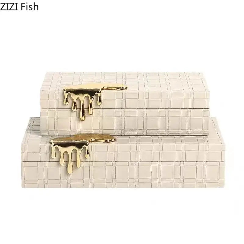 Cream-colored leather jewelry box with textured grid pattern and gold-tone silver drip clasp hardware for elegant storage
