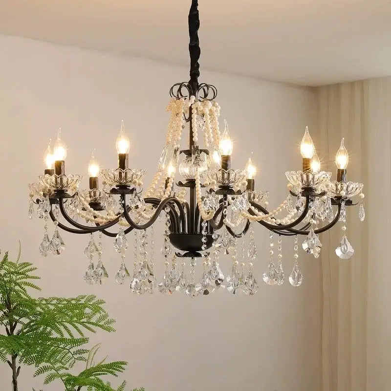 Elegant black crystal chandelier with pearls featuring wrought iron, clear crystals, and white pearl strands by decorbites black crystal