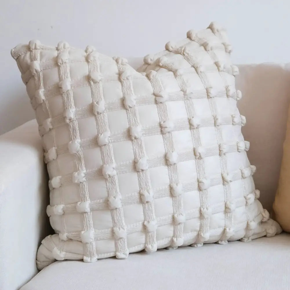 Cream-colored cushion cover with textured dot bubble pom pom design perfect for home decor and bedroom use