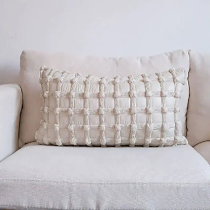 Cream-colored rectangular cushion cover with textured woven dot bubble pattern and raised tassels for home decor
