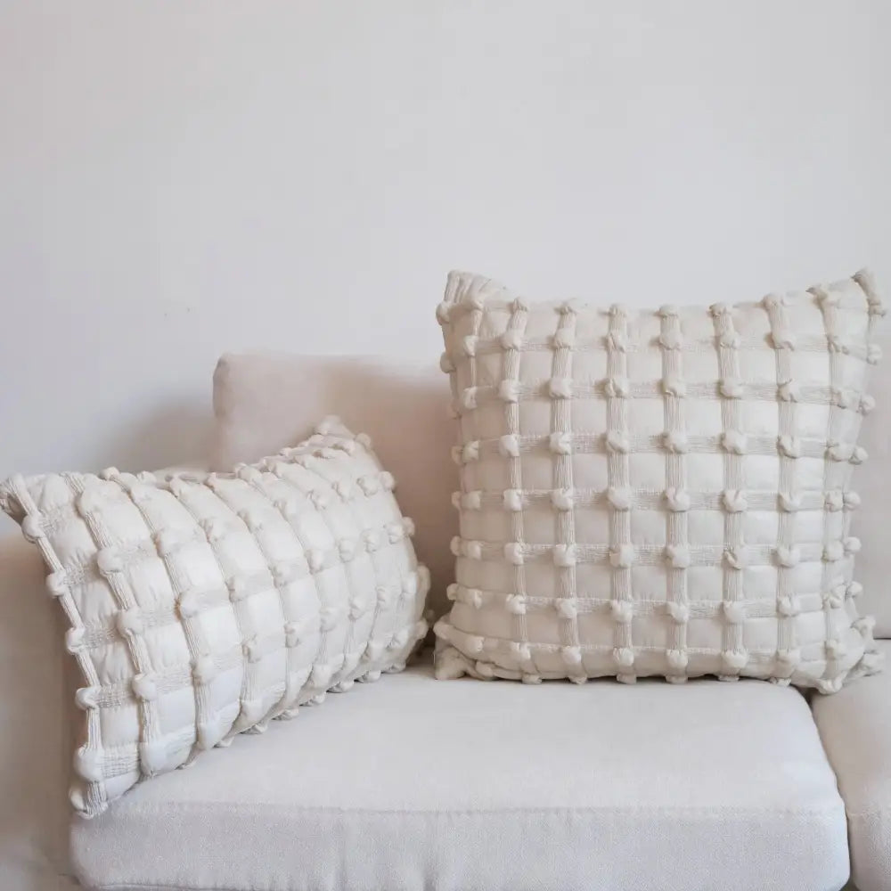 Cream-colored textured cushion cover with woven pom-pom dot bubble pattern for home decor and bedroom use