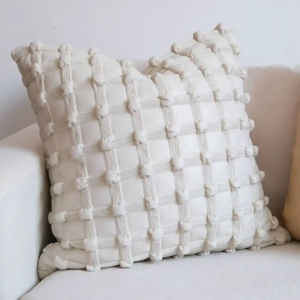 Cream-colored cushion cover with textured dot bubble pom pom quilted pattern for stylish home decor