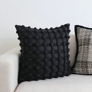 Black dot bubble quilted cushion cover with textured woven pattern and pom pom accents for home decor