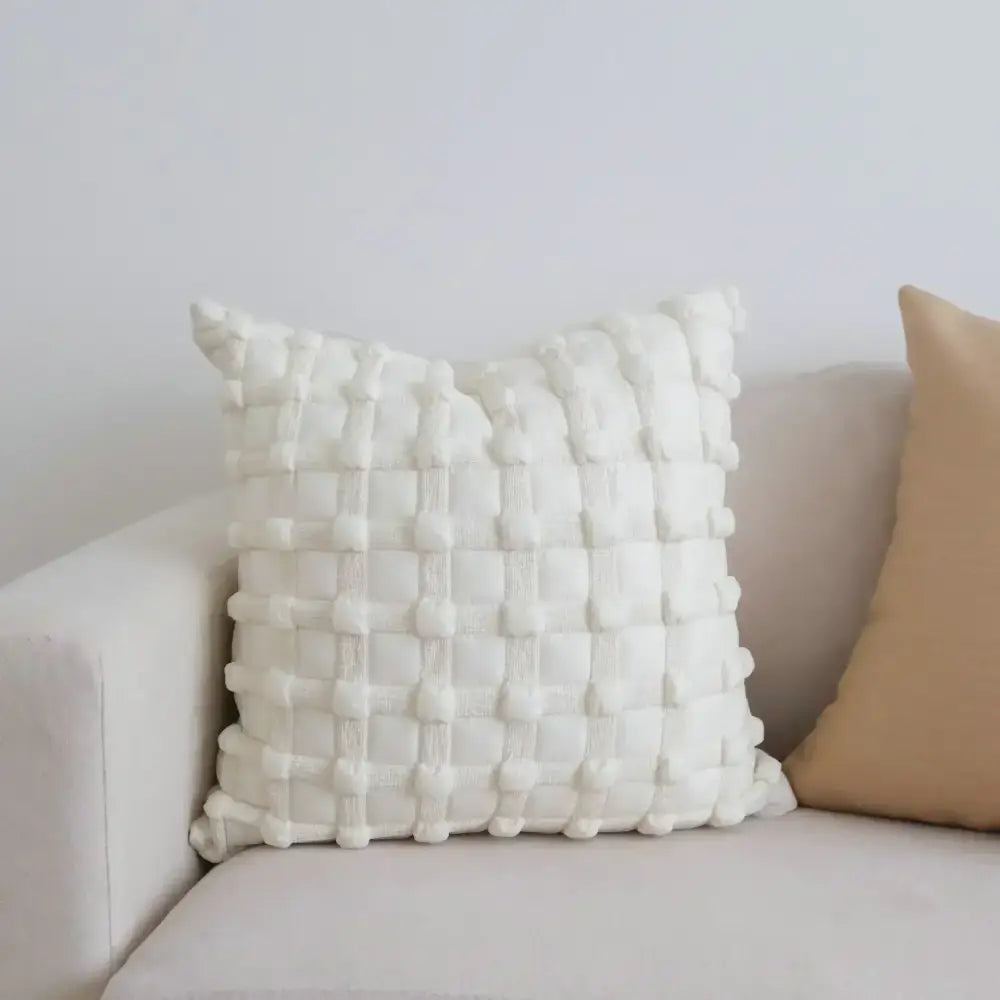 White textured throw pillow with woven three-dimensional grid pattern complementing dot bubble cushion cover home decor