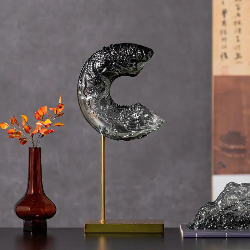 Black glass dragon sculpture with intricate carvings on a gold stand for decorbites crescent moon living room decor