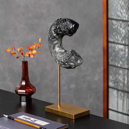 A sleek black glass dragon sculpture with intricate carvings and glossy finish for decorbites crescent moon decor