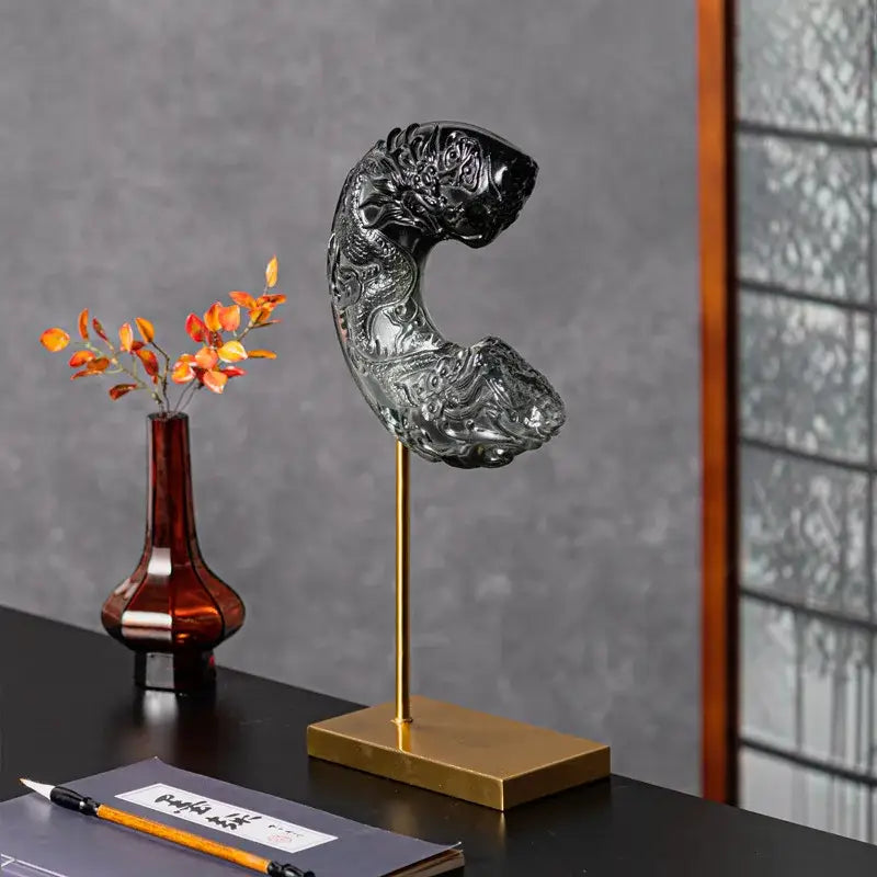 A sleek black glass dragon sculpture with intricate carvings and glossy finish for decorbites crescent moon decor