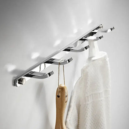Chrome finished wall-mounted robe rack with five curved hooks made of decorbites brass in black gold for towel storage