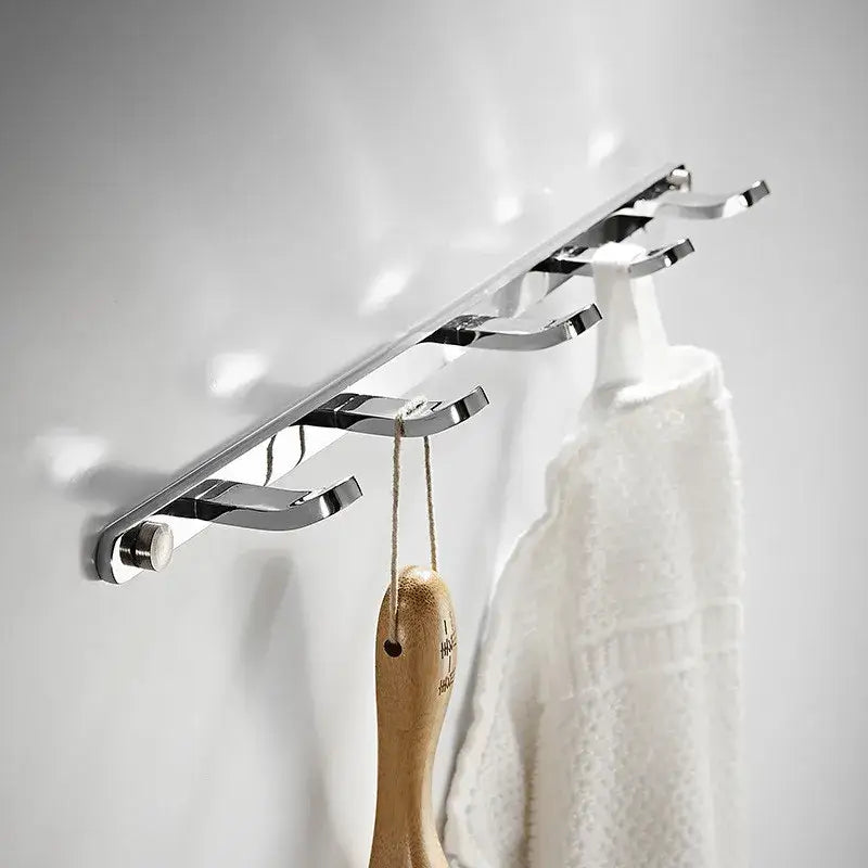 Chrome finished wall-mounted robe rack with five curved hooks made of decorbites brass in black gold for towel storage