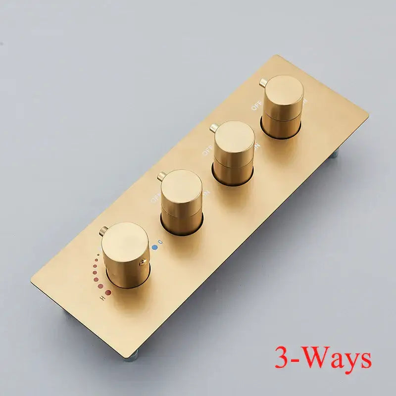 Gold-colored brass thermostatic faucet with three cylindrical knobs and temperature indicators for bathroom shower use