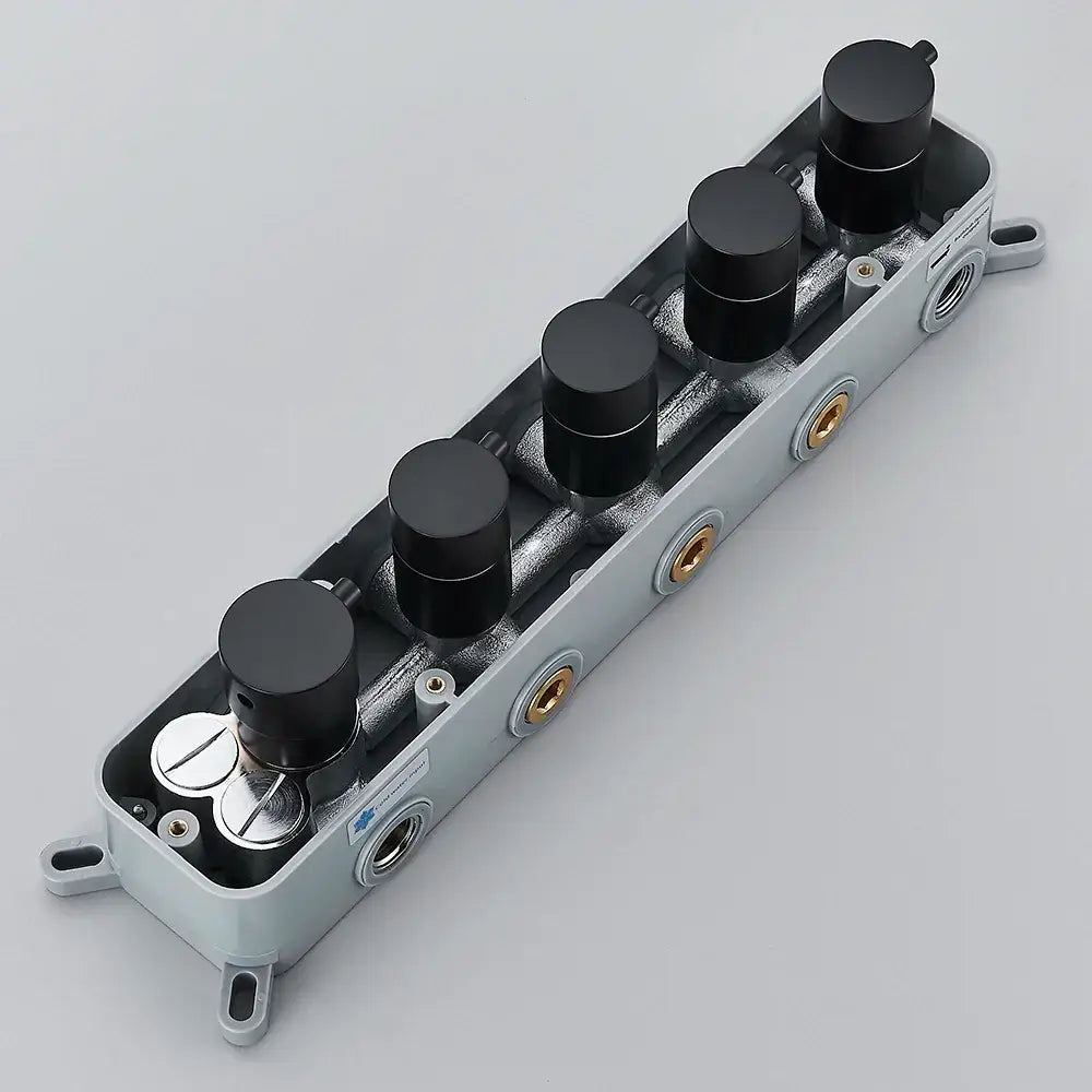 Gray plastic housing with five black knobs and gold threaded ports on the back of a brass thermostatic faucet mixer