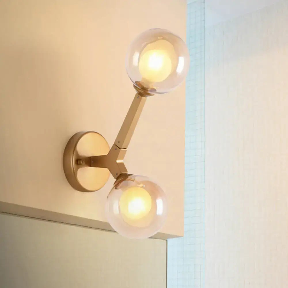 Black and gold bubble wall sconce with two glass globes in gold tone for bedroom lighting