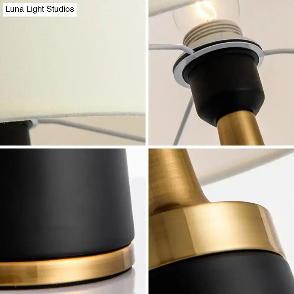 Decorbites drum bedside lamp with black and gold matte base, brass accents, off-white fabric shade, led incandescent fluorescent compatible 220v-240v 110v-120v