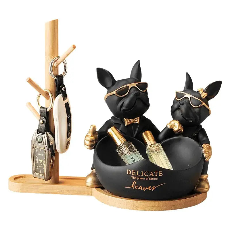Black and gold french bulldog butler statue holding perfume bottles with sunglasses and bow ties in decorative bowl