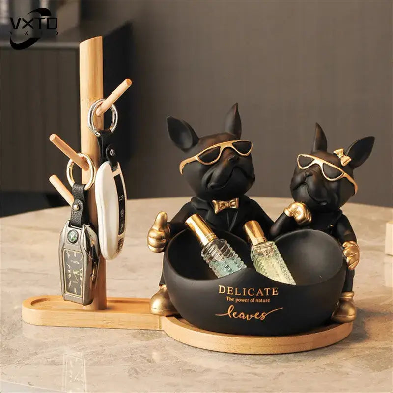 Black and gold french bulldog butler statue desk organizer with sunglasses bow tie and holding perfume bottles