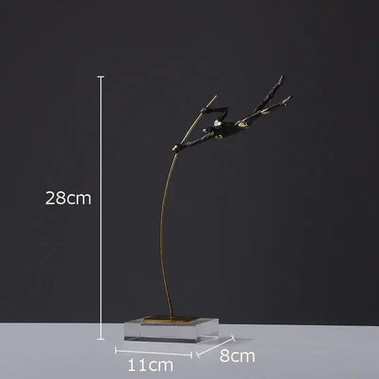 A sleek black and gold gymnastic acrobat resin sculpture on a clear acrylic base for living room decor by decorbites